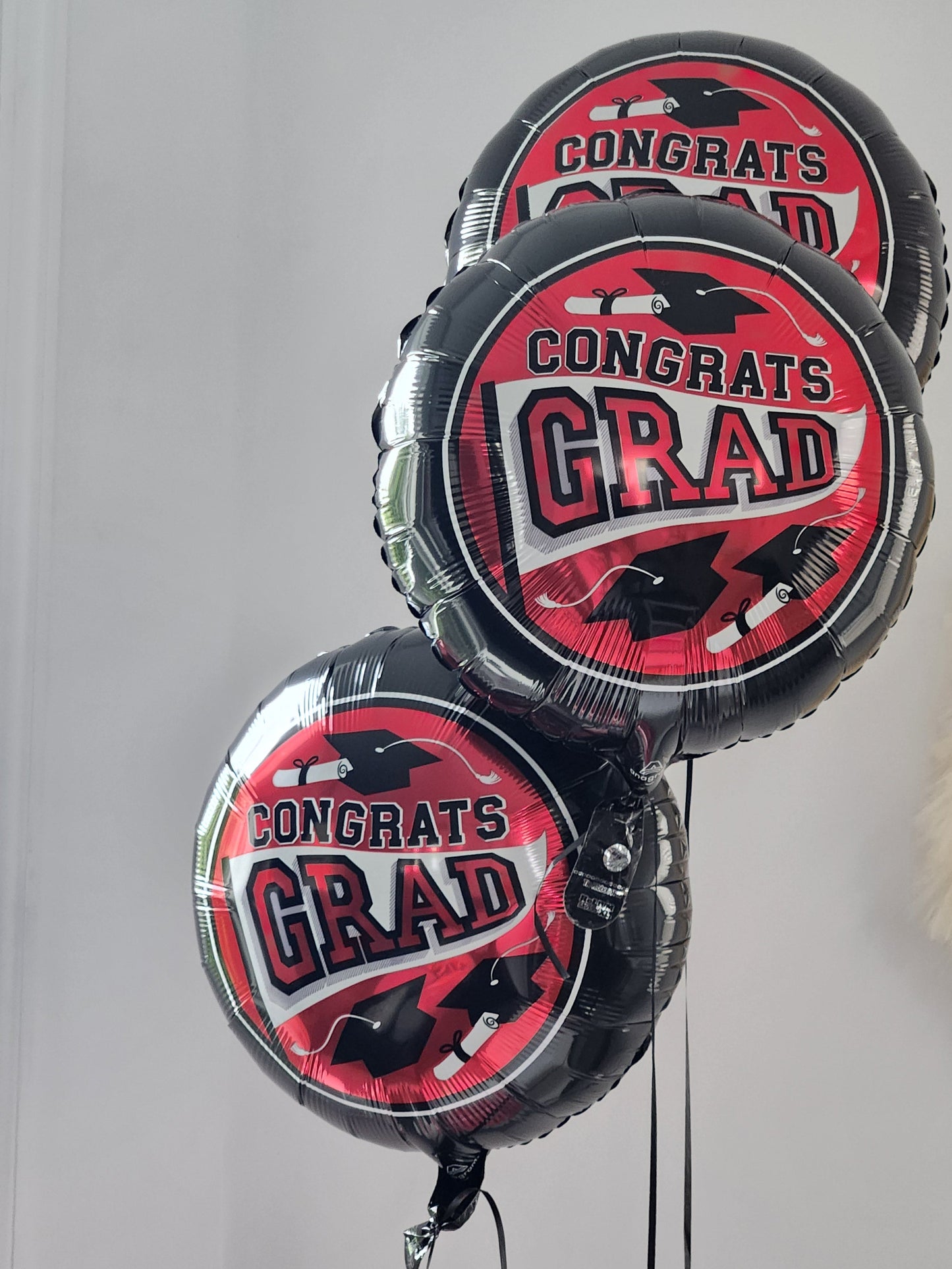 foil balloon black with red circle congrats grad with cap in the middle